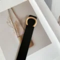 Minimalist women's thin black leather belt with gold C-shaped buckle, stylish waist accessory. - Black