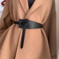 Stylish black faux leather waist belt for women, featuring a chic knot design for coats. - Black