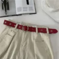 Red leather belt for women with metal round buckle and eyelets, trendy jeans accessory. - Red / 105cm