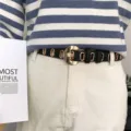 Womens casual leather belt with metal round buckle and eyelets, stylish waist accessory for pants. - Black