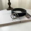 Minimalist black leather belt with silver double O-ring metal buckle, detail view. - Black Double Round Silver Buckle