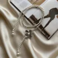 Elegant pearl waist chain with metallic flower pendant, chic accessory for dresses and skirts. - Silver