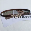 Detail view of women thin leather dress belt with gold chain buckle, adjustable waist strap. - Coffee