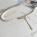 Minimalist women slim white leather belt with gold metal buckle detail flat lay display. - Beige