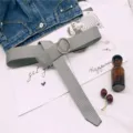Grey canvas belt with metal round buckle, minimalist casual style for everyday wear. - Gray