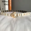 Women's white casual leather belt with gold metal eyelets and round pin buckle accessory - White