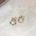 Detailed close-up view of elegant bow pearl rhinestone stud earrings with gold finish. - 5# Gold Pearl Rhinestone Bow Knot Style