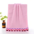 Pure cotton pink face towel with embossed circles and colorful dot border for home daily use. - Interlocking Rings Style, Pink
