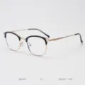 Close-up detail of vintage metal semi-rimless optical glasses frame in black and gold. - Gold Black C1