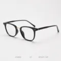 Close-up detail of retro black optical glasses frame with stylish gold bridge accent. - Glossy Black/Gold C1