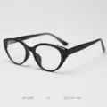 Close-up detail of stylish black optical eyeglasses frame, modern retro cat-eye design. - Glossy Black C1