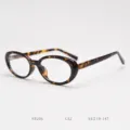 Close-up detail of vintage tortoise shell oval optical glasses frame, stylish unisex clear retro eyewear. - Tortoiseshell C32