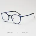 Detailed view of KBT98162 retro round optical glasses frame in dark blue plastic steel. - Sapphire Blue