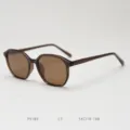 Detailed view of stylish polygonal sunglasses featuring brown gradient lenses and translucent frame. - Brown Tea All Tea C3