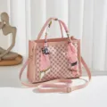 Stylish pink monogram tote bag with chic handle scarf and adjustable crossbody strap. - Pink