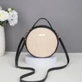 Round straw woven crossbody bag with black PU leather trim, top handle and adjustable strap. - 17*6*17 / Black