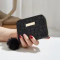 Black short women wallet with cute furry ball charm, stylish PU coin purse variant. - Black