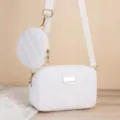 White quilted crossbody camera bag with a small round pouch and gold tone hardware. - White