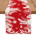 Christmas red table runner fabric detail showing white snowflake and pine branch design. - Red Base Holiday Print Pattern