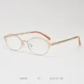 Details of vintage small oval metal optical frame eyeglasses with orange temple tips clearly shown. - Matte Gold Clear Lenses C7
