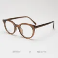 Detailed shot of retro round optical glasses frame with titanium temples and stylish brown finish. - Transparent Brown C5