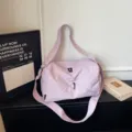 Stylish light purple travel duffel bag with geometric panel design and shoulder strap. - Purple