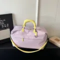 Stylish large capacity travel duffel bag with yellow handles and crossbody strap for short trips. - Purple