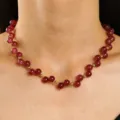 Elegant red round beaded necklace with small gold spacer beads worn by a female model - Bead Necklace(K-1159)