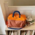 Grande borsa da viaggio borsone, motivo a quadri arancione e marrone con manici e tracolla blu. - 40*21*25 / Arancione