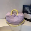 Large capacity travel duffel bag for women and men, stylish gym sports bag with yellow handles. - Purple