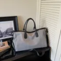 Large capacity herringbone pattern travel duffel bag with black handles and shoulder strap - Gray