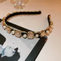 Detail view of a luxury pearl rhinestone headband, elegant French court style hair accessory. - Champagne