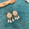 Close-up detail of vintage gold baroque bee pearl earrings with hanging teardrop pearls. - 12# Silver Needle Earrings - Golden Oval Bee