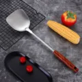 Stainless steel spatula with wooden handle, long kitchen cooking utensil for stir fry. - Spatula