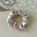 Close-up of minimalist solid color satin hair scrunchie detail, smooth ice silk texture. - 2cm Width / Pink