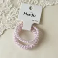 Close-up of pink phone cord hair ties with cute pattern on card and delicate white lace. - Two-Piece Set / Purple Rabbit