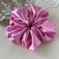 Close-up of a large pink satin scrunchie detail, soft glossy fabric for gentle hair styling. - Large Size Dark Pink 20cm