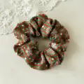 Close-up detail of the Christmas themed hair scrunchie with red green stripes and snowflakes. - Green Striped Snowflake