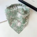 Close-up detail of the green floral chiffon triangle headband with elastic band design. - Small Green Tie-Dye Bandana