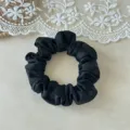 Close-up of a sleek black satin hair scrunchie on a lace background, soft touch, simple style. - 2cm Width / Black