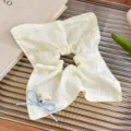 Close-up detail of cream white scrunchie with cute blue bow and mini bear charm for sweet hairstyles. - Light Yellow Bear Square Scarf