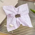 Close-up detail of the sweet pastel purple hair scrunchie with a cute plush bear and ribbon. - Light Purple Bear Square Scarf