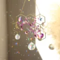 Crystal suncatcher detail featuring hexagonal metal frame, purple stone chips and rainbow pendants. - Purple Crystal