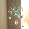 Exquisite honeycomb suncatcher with natural turquoise crystal prisms and hanging geometric charms. - Blue Turquoise