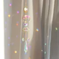 Detailed close-up view of hanging golden crystal suncatcher featuring tree of life and prisms. - Amethyst Tree of Life
