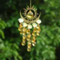 Crystal suncatcher hanging ornament with gold sun and moon metal frame and amber crystals. - New Flame Moon / Yellow