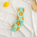 Mint green cotton mid-tube socks featuring cute smiley sun floral pattern. Soft and stylish. - One Size / Green