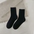 Black mid-calf socks for women, comfortable daily casual hosiery, solid color knit wear. - One Size / Solid Black