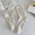 Cozy speckle knit crew socks featuring cute pink heart embroidery for casual daily wear. - Milky White