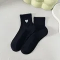 Black short socks for women featuring a cute white heart embroidery and ribbed cuff design. - One Size / Black